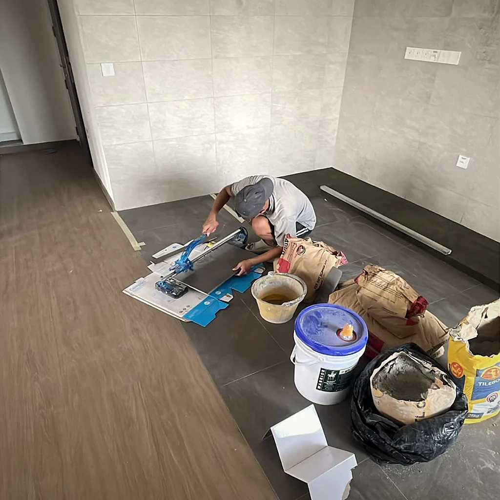 A YC tiler cutting a large-format tile on site