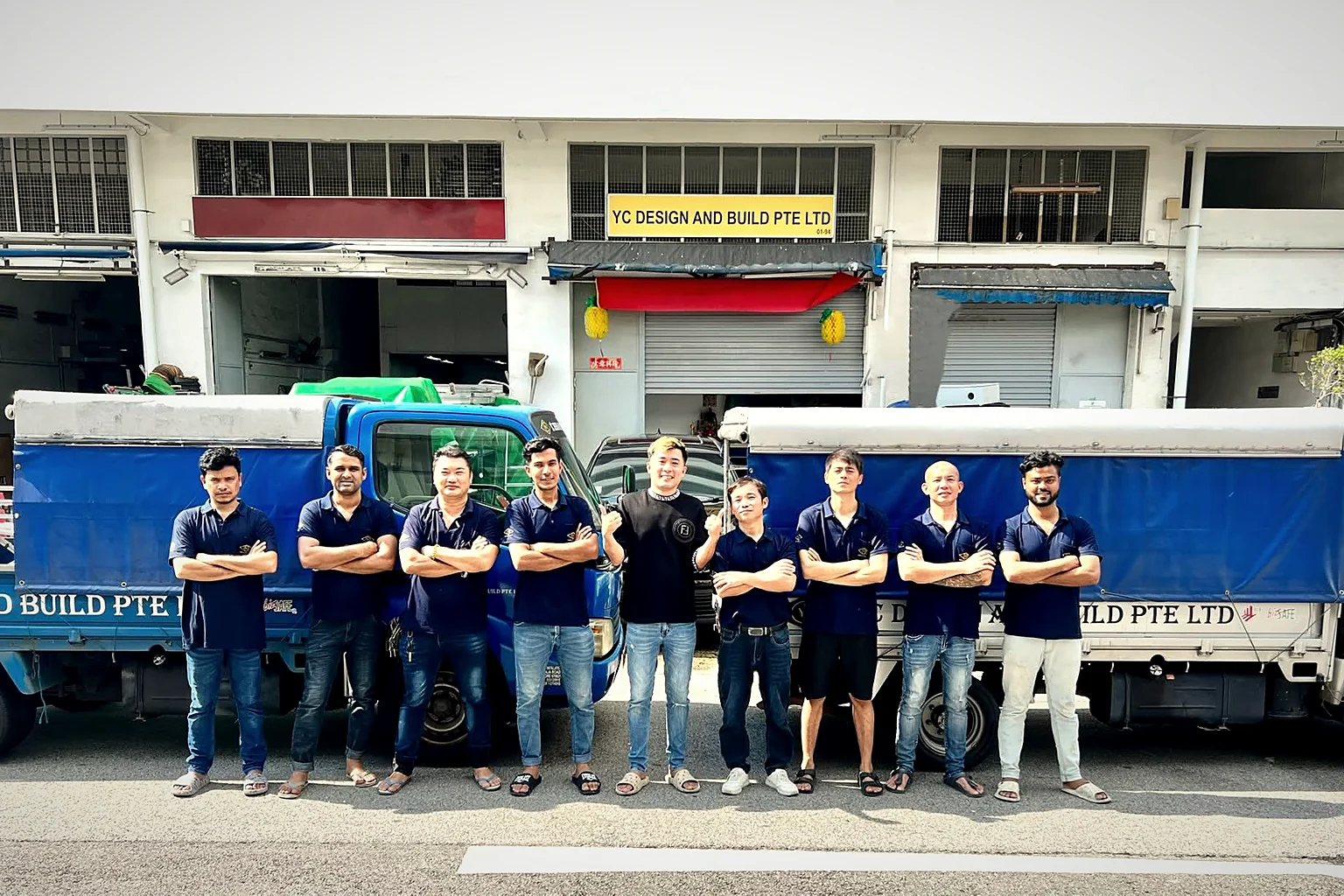 The YC Design and Build crew outside the workshop with the company lorries